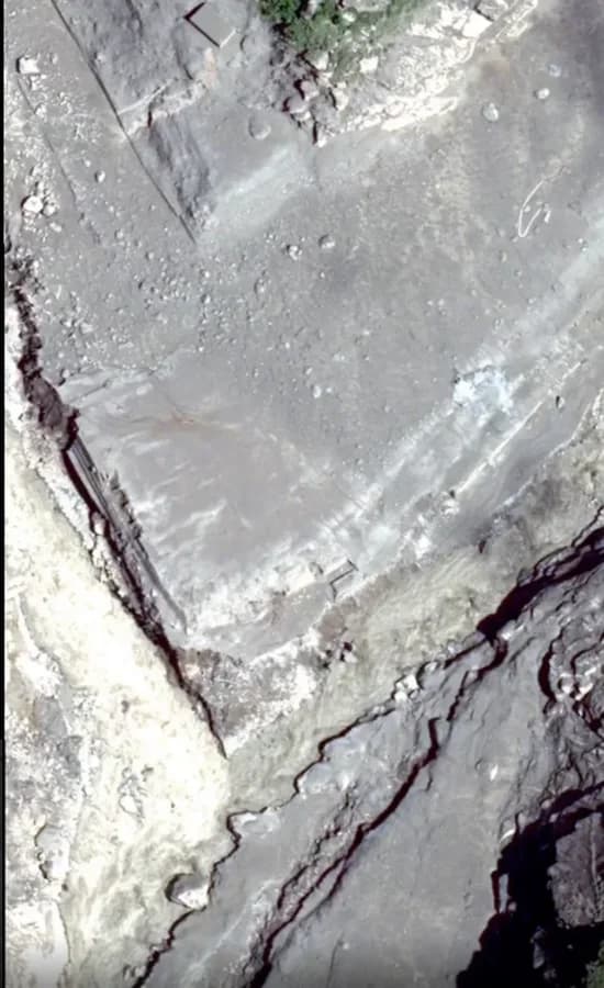 The same river corridor buried by flood debris